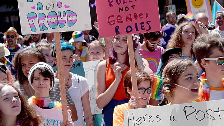Seattle Pride parade showing teenagers holding signs 